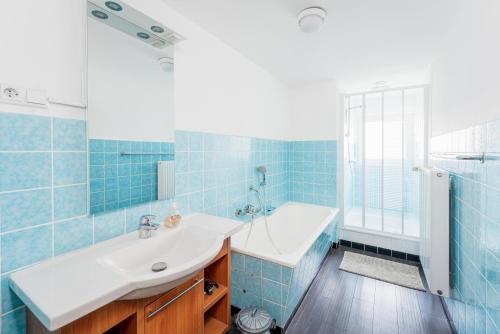 a bathroom with a sink and a tub and a shower at Haus am Wilde Aar in Medebach