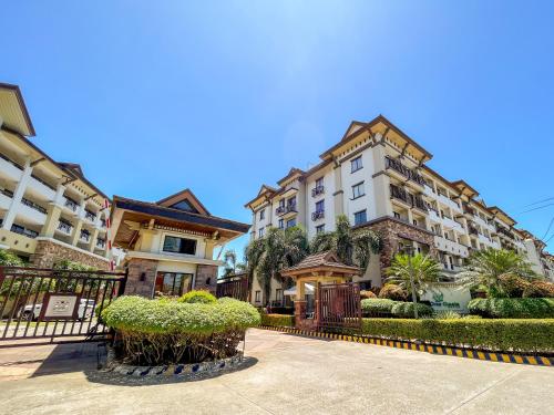 a row of buildings with trees and bushes at Modern 2BR Condo Near SM with Free Parking Pool WIFI and Netflix in Davao City