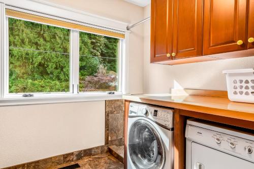 a kitchen with a washing machine and a window at Whatcom By The Water in Bellingham