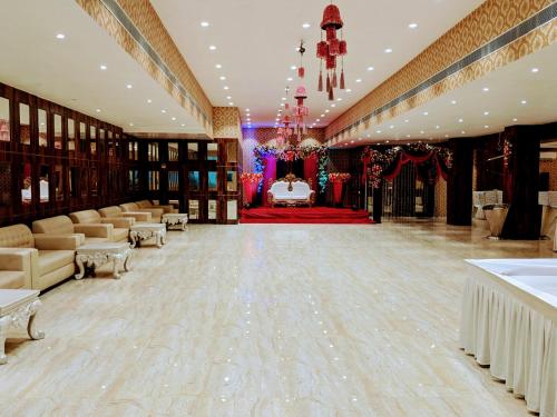 a large banquet hall with a bed and a table at THE PRESTIGE HOTEL & CONVENTION in Rourkela