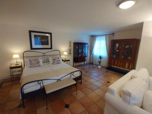 a large bedroom with a bed and a couch at Wein- und Landhaus S A Prüm in Bernkastel-Kues