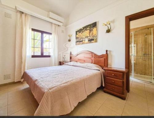 a bedroom with a bed and a dresser and a window at VILLA ANGELINA in Playa Blanca