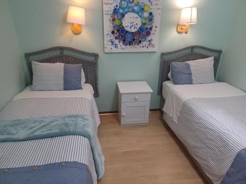 2 aparte bedden in een kamer met 2 lampen bij Brookes Hill suites no 18 in Port Elizabeth