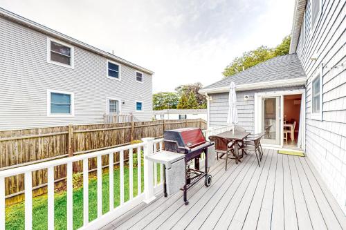 a patio with a table and a grill on a deck at Coastal Gem in York