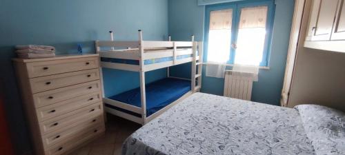 a bedroom with a bunk bed and a dresser at CasAmare in Torvaianica
