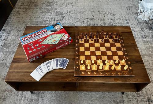 a table with a chess board and a monopoly game at Chic, Spacious Home You'll Love in Markham