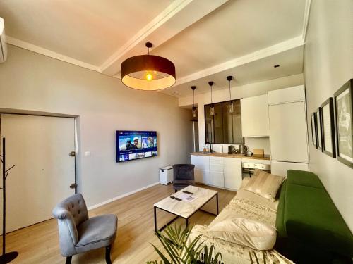 a living room with a couch and a table at Nouveau Loft: vieille-ville, musée Picasso, marché in Antibes