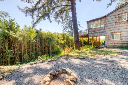 a house with a stone circle in the yard at Bamboo House - Meredith Lodging in Nehalem