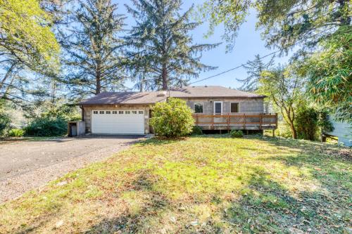 a house on a hill with a garage at Bamboo House - Meredith Lodging in Nehalem