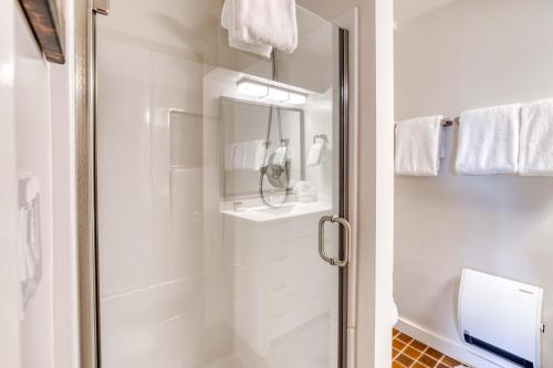 a bathroom with a shower with a glass door at Bamboo House - Meredith Lodging in Nehalem
