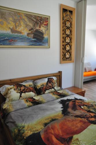 a bedroom with a bed with a painting on the wall at Vastu Dead Sea apartment in Arad