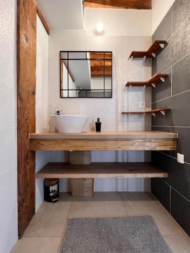 une salle de bain avec un lavabo et un miroir dans l'établissement Beau T3 au cœur du centre ville, à Narbonne