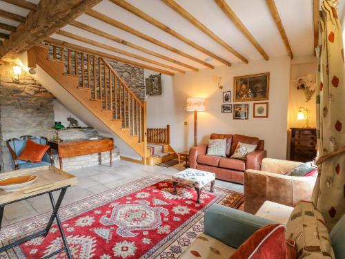 a living room with a staircase and a couch at Pen Bont Home Farm in Brecon