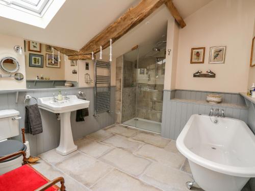 a bathroom with a tub and a sink and a shower at Pen Bont Home Farm in Brecon