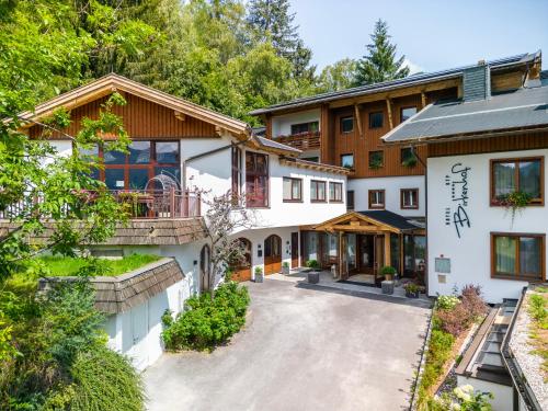 an exterior view of a house with a driveway at Hotel OTP Birkenhof in Bad Kleinkirchheim