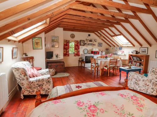 a living room with a bed and a dining room at Ryan's Loft in Ardfinnan