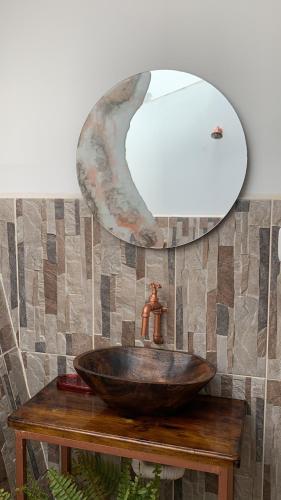 a bathroom with a bowl sink and a mirror at La Paloma Glamping in Palestina