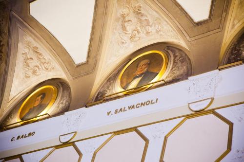 two statues of two men in a building at Hotel Bernini Palace in Florence