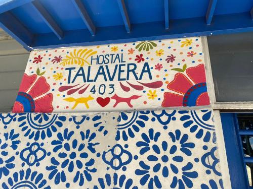 a sign for a festival of talavera on a wall at Hostal Talavera in Puebla