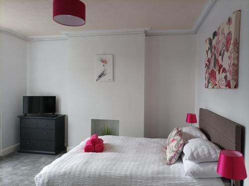 a bedroom with a bed with a teddy bear on it at Victorian Renovation Room 3 in Liverpool