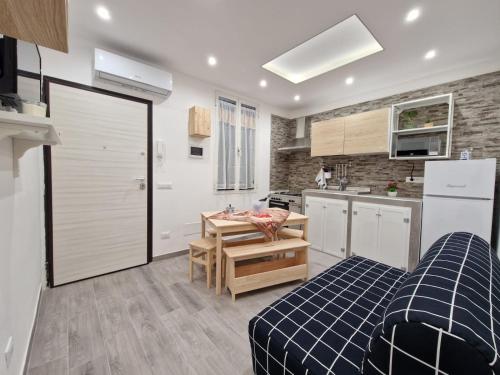a kitchen with a bed and a table in a room at La casa di Teresa in Taranto