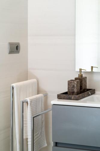 a white bathroom with a towel and a towel rack at Apartment Harmony in La Cala Golf, Mijas Spain in Málaga