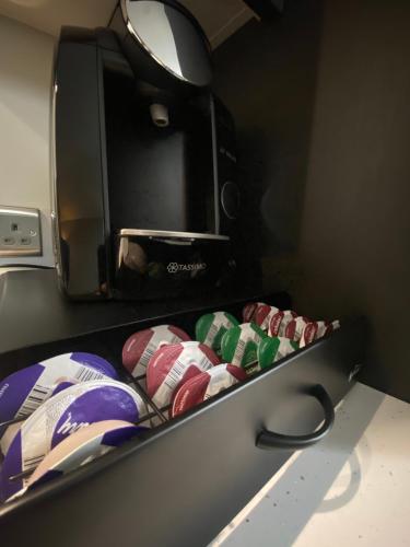 a shelf with many different colored pillows on it at 3 West End Boutique Apartment in Bowness-on-Windermere