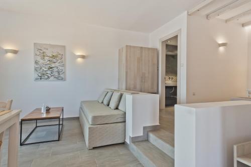 a living room with a couch and a table at Alsalos villas in Amoopi