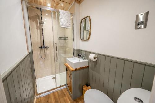 a bathroom with a shower and a sink at Coorie In in Kilmore