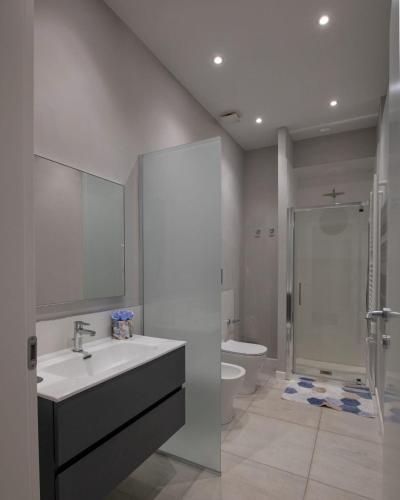 a bathroom with a sink and a shower and a toilet at La Casa di Andre in Sanremo