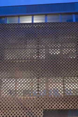 a brown metal wall with a building in the background at Mari's: Multifunctional Shelter with big Garden in Ghent