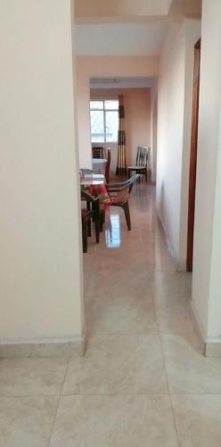 a hallway with a living room and a table at Adorable 2bedroom homestay in Beau Bassin