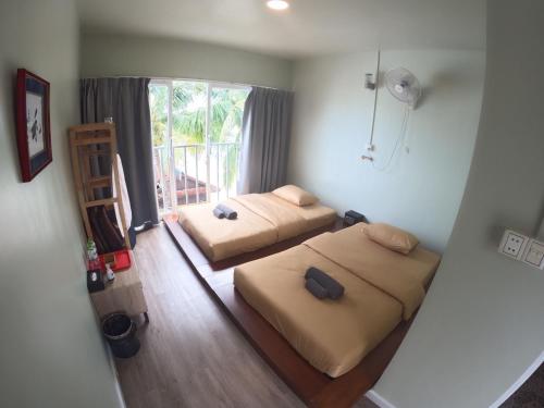 a bedroom with two beds and a window at WHITE SAND ARK RESORT in Koh Rong Island
