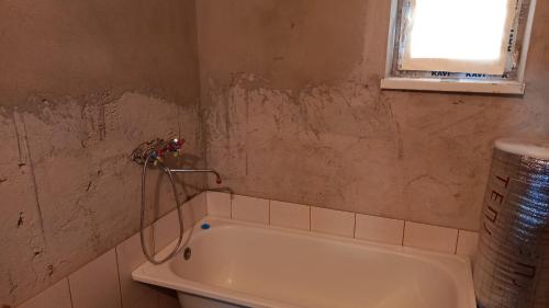 a bathroom with a bath tub in a room at Дом в селе Сайын Шапагатов in Segendy
