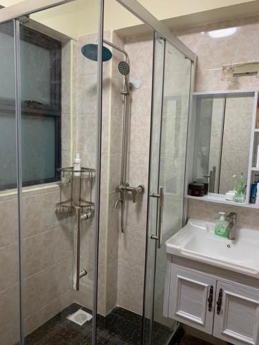 a bathroom with a glass shower and a sink at New Luxury Apartment close to State House Nairobi in Nairobi