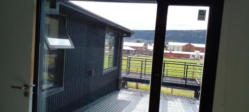 a view of a balcony with a view of a field at La Pancora in Esquel