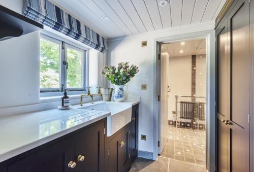 a bathroom with a sink and a window at Hilltop Cottage in Chalbury
