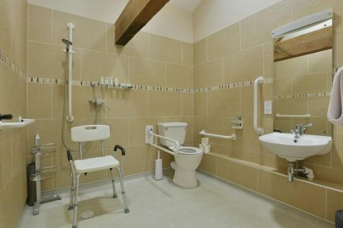 a bathroom with a toilet and a sink at Sheldon Cottage in Buxton