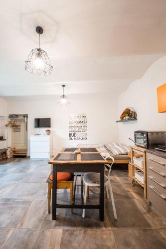 a kitchen and dining room with a table and chairs at Apartmán ve Dvoře in Ratíškovice