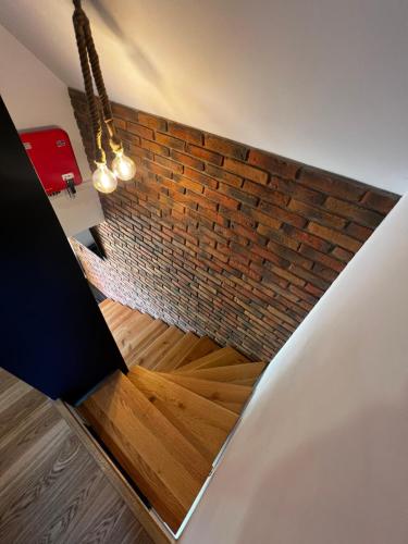 a brick wall and wooden floor in a room at PETE HOUSE in Ustrzyki Dolne