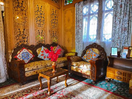 a living room with two couches and a table at The Heritage Gemini Group of Houseboat in Srinagar