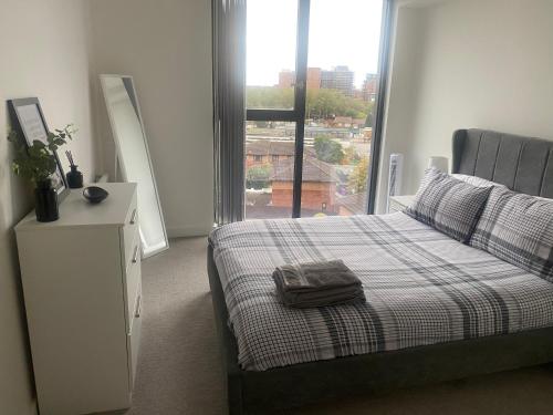 a bedroom with a bed and a large window at Modern 1 Bedroom Apartment by BOLD Apartments in Liverpool