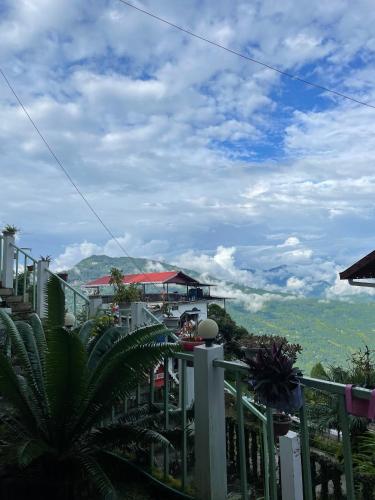 a balcony with a view of the mountains at THE GINGKO EYRIE in Kalimpong