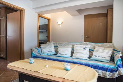 a living room with a couch with pillows on it at Neue Reihe 8 Wohnung links in Cuxhaven