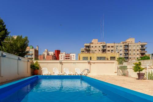 a swimming pool on the roof of a building at Millennium Inn Mendoza in Mendoza