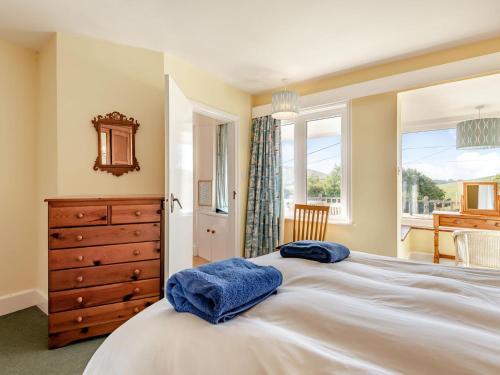 a bedroom with a large bed with two towels on it at Advantage Point in West Lulworth
