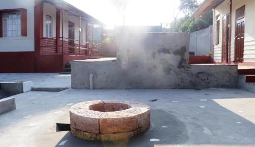 a wooden stump sitting in front of a building at K & K INN in Cherrapunji