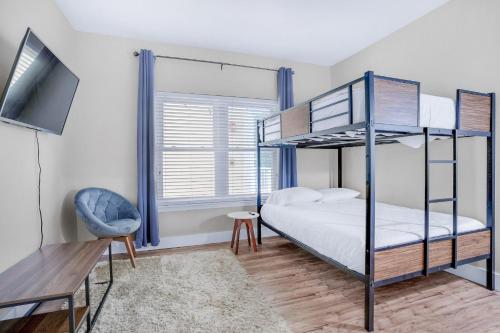 a bedroom with two bunk beds and a television at Pointe of View 407- Penn's Paradise in Destin