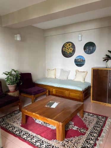 a living room with a couch and a coffee table at THE GINGKO EYRIE in Kalimpong