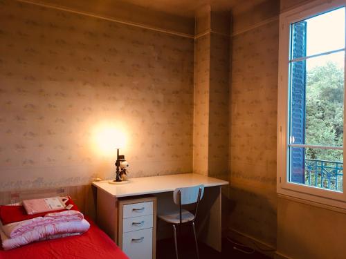 - une chambre avec un bureau, un lit et une fenêtre dans l'établissement Comfortable Paris 1, à Vitry-sur-Seine